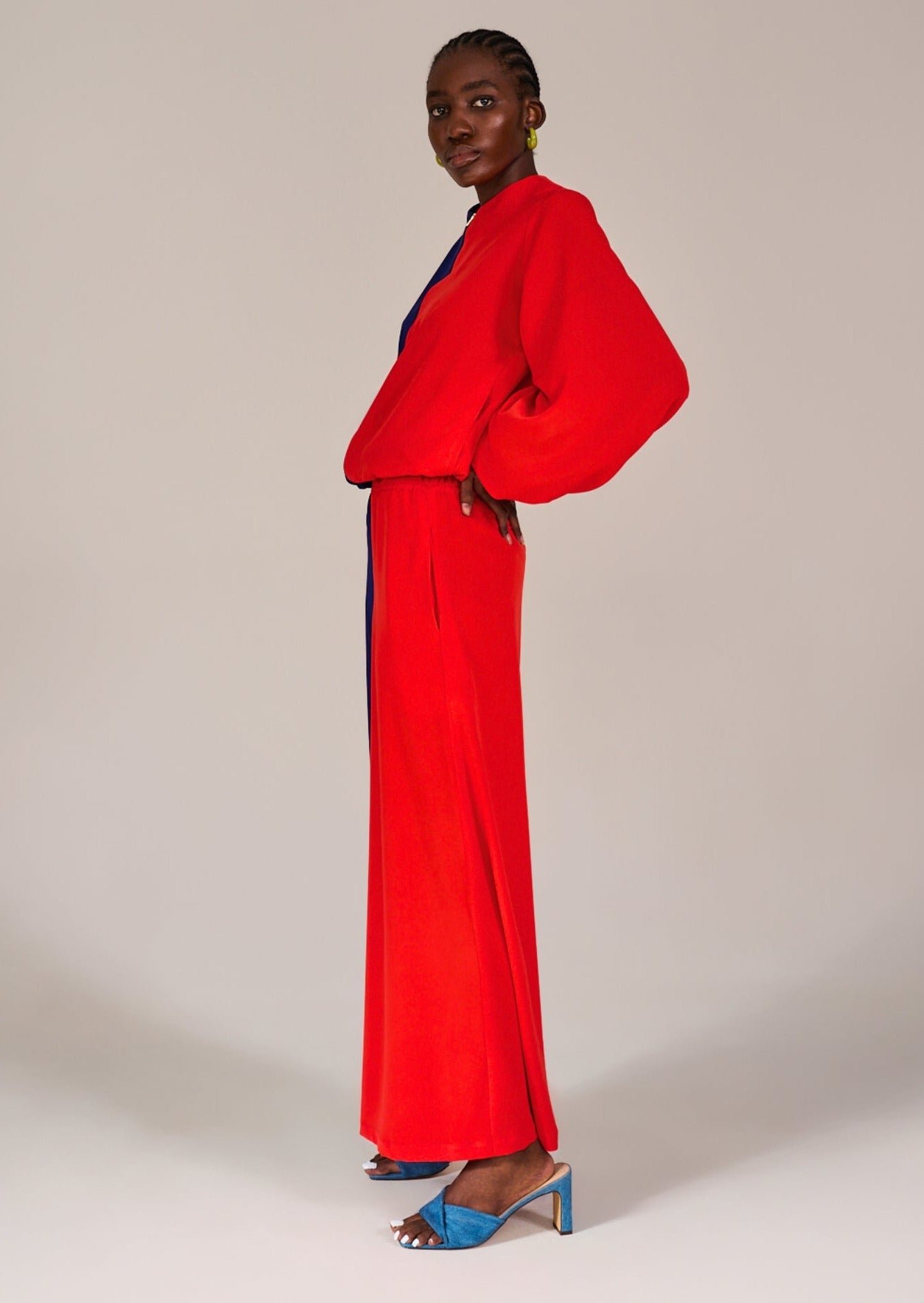 Model standing sideways wearing the Mouille Color Block Bomber Jacket and the Greenpoint Color Block Pants by KAHINDO