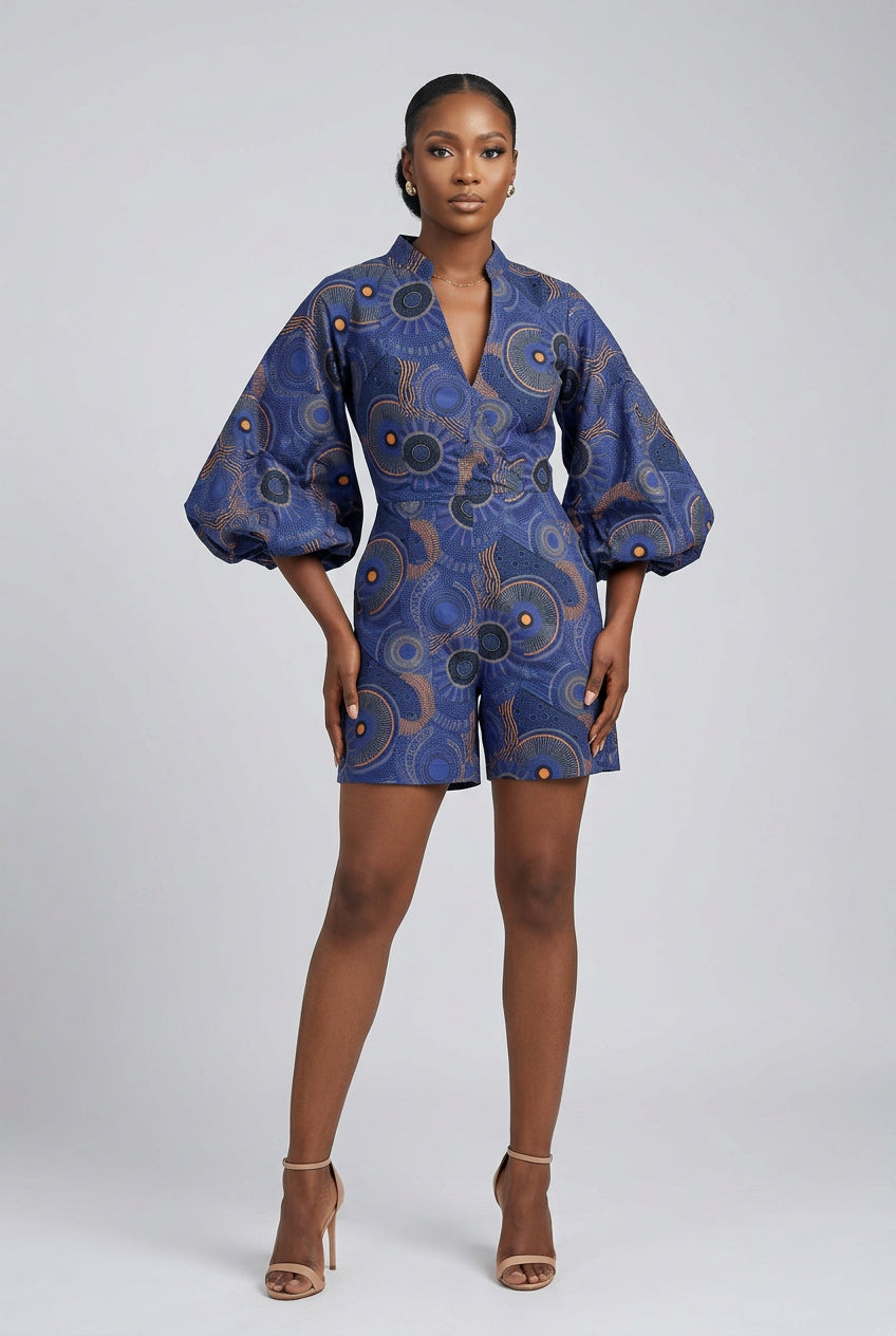 Person wearing a blue patterned outfit on a white background