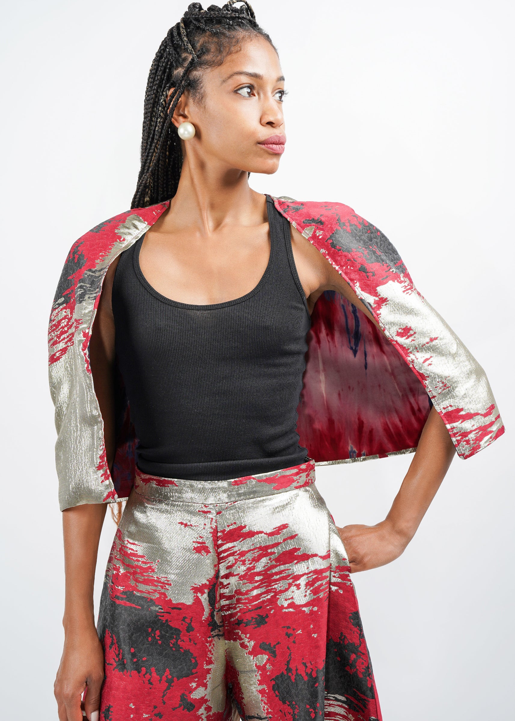Model standing forward, showing her right side profile, in the Masego Cape.