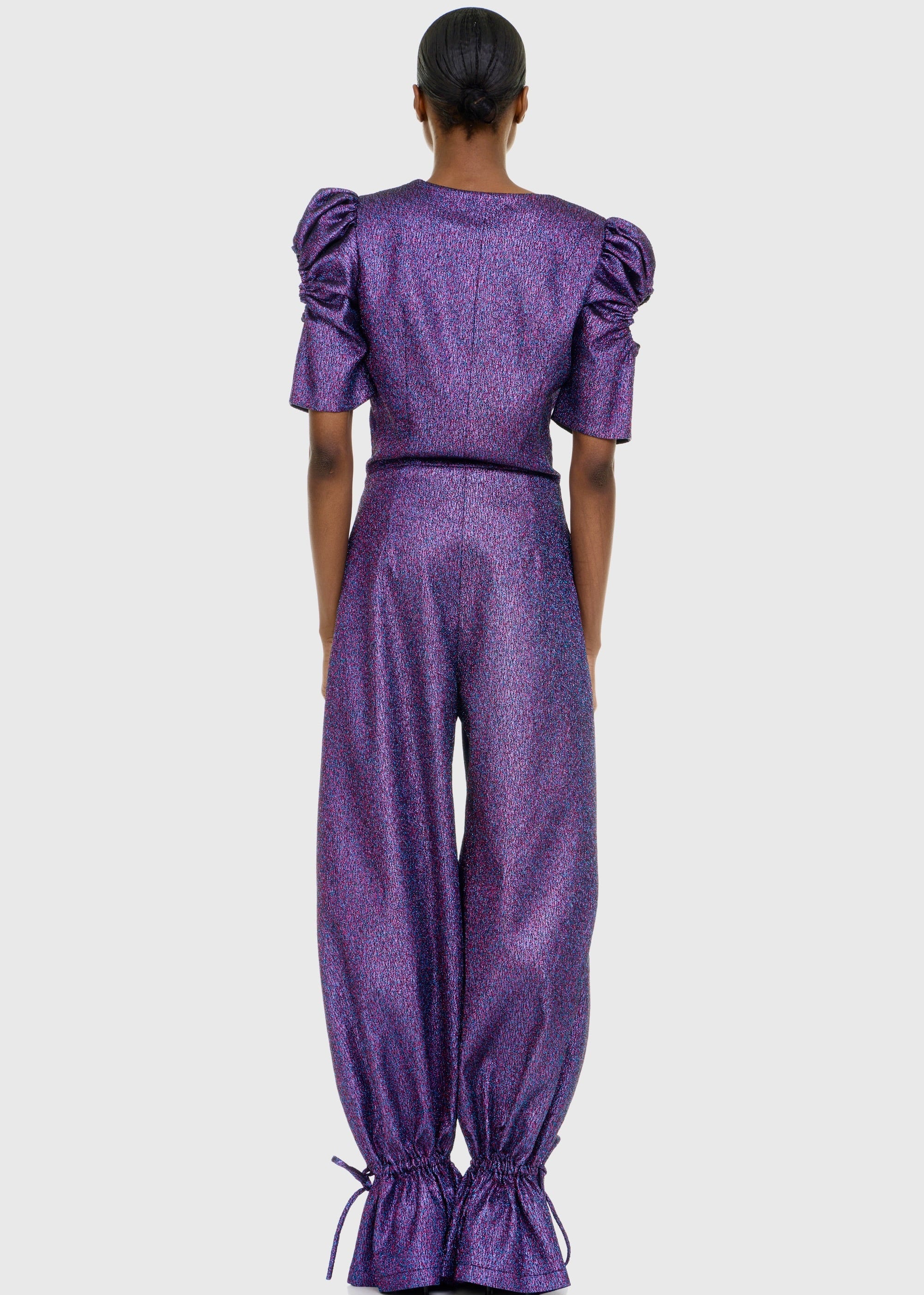 Black woman wearing Purple Shimmer Jumpsuit