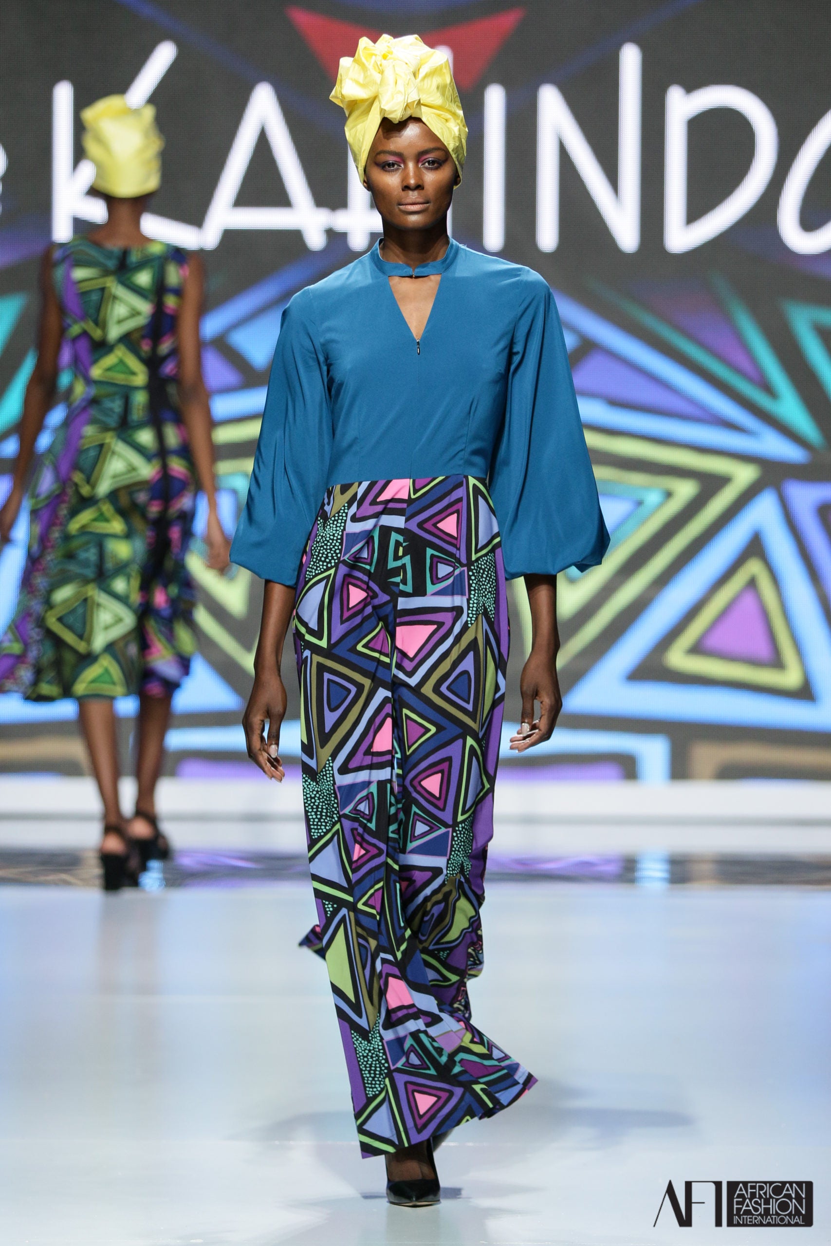 Model wearing the Zip Front Jumpsuit on the runway.