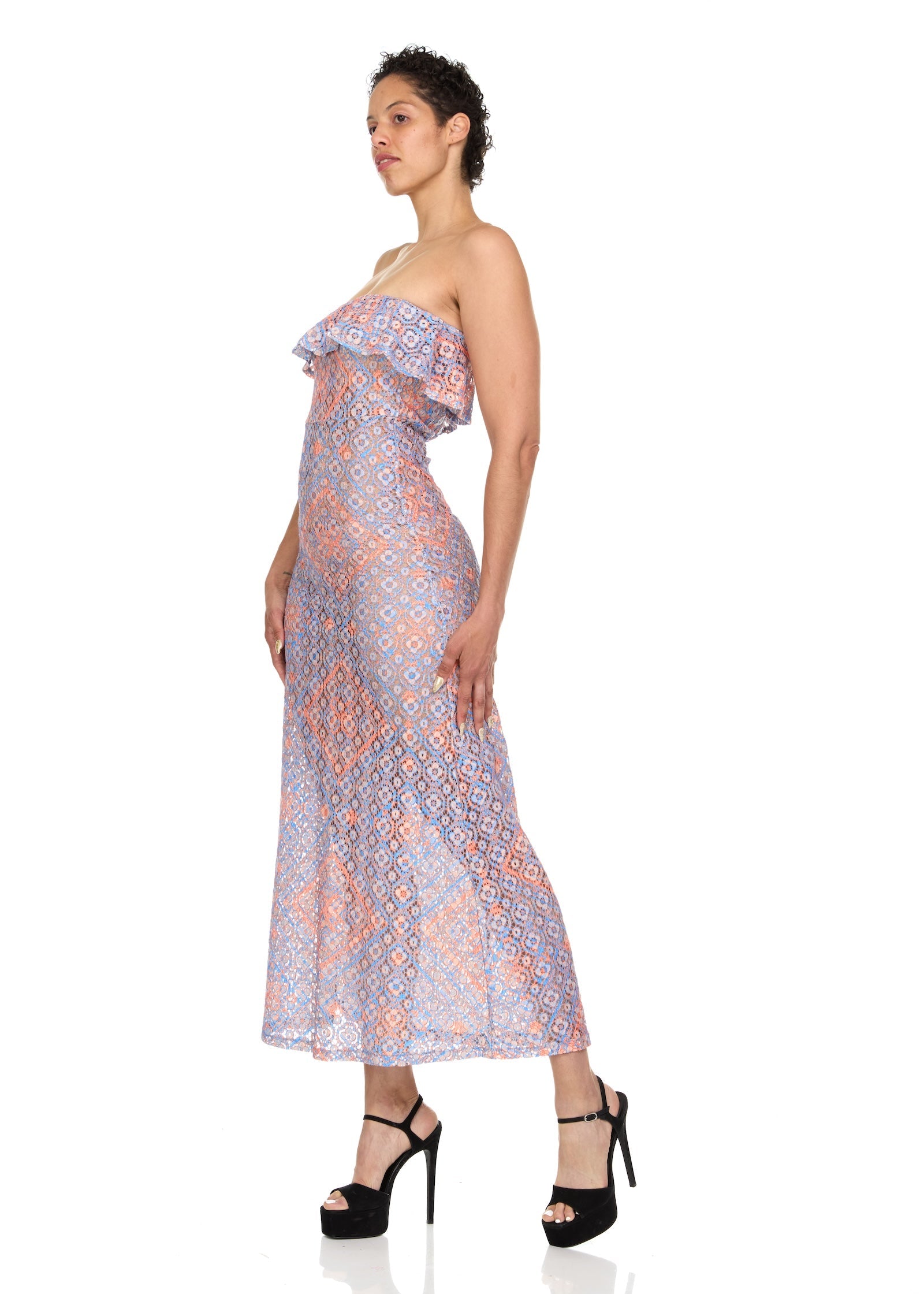 The model is shown in profile, facing the left side to highlight the flattering strapless neckline and peplum detail that adds soft structure to the silhouette. Ethically made in Turkey from a comfortable blend of polyamide, cotton, and viscose.