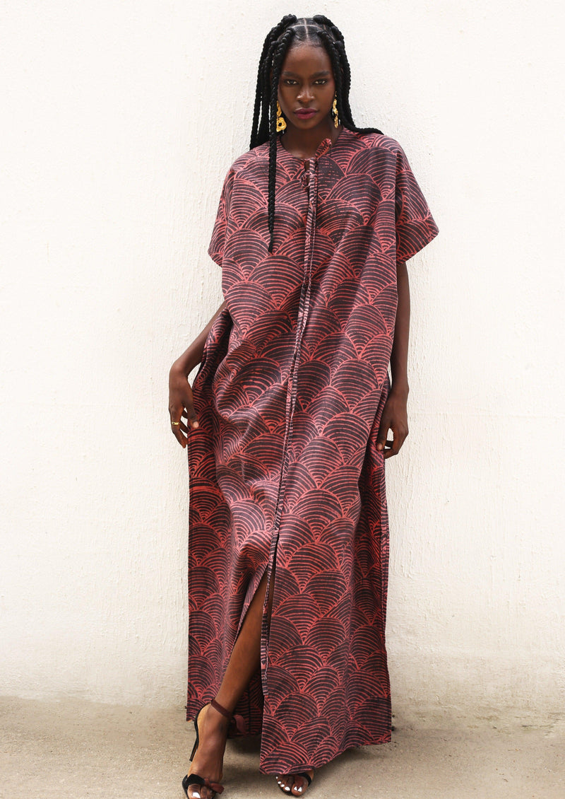 Full-length view of a woman wearing the Amboseli Kaftan with African-inspired print