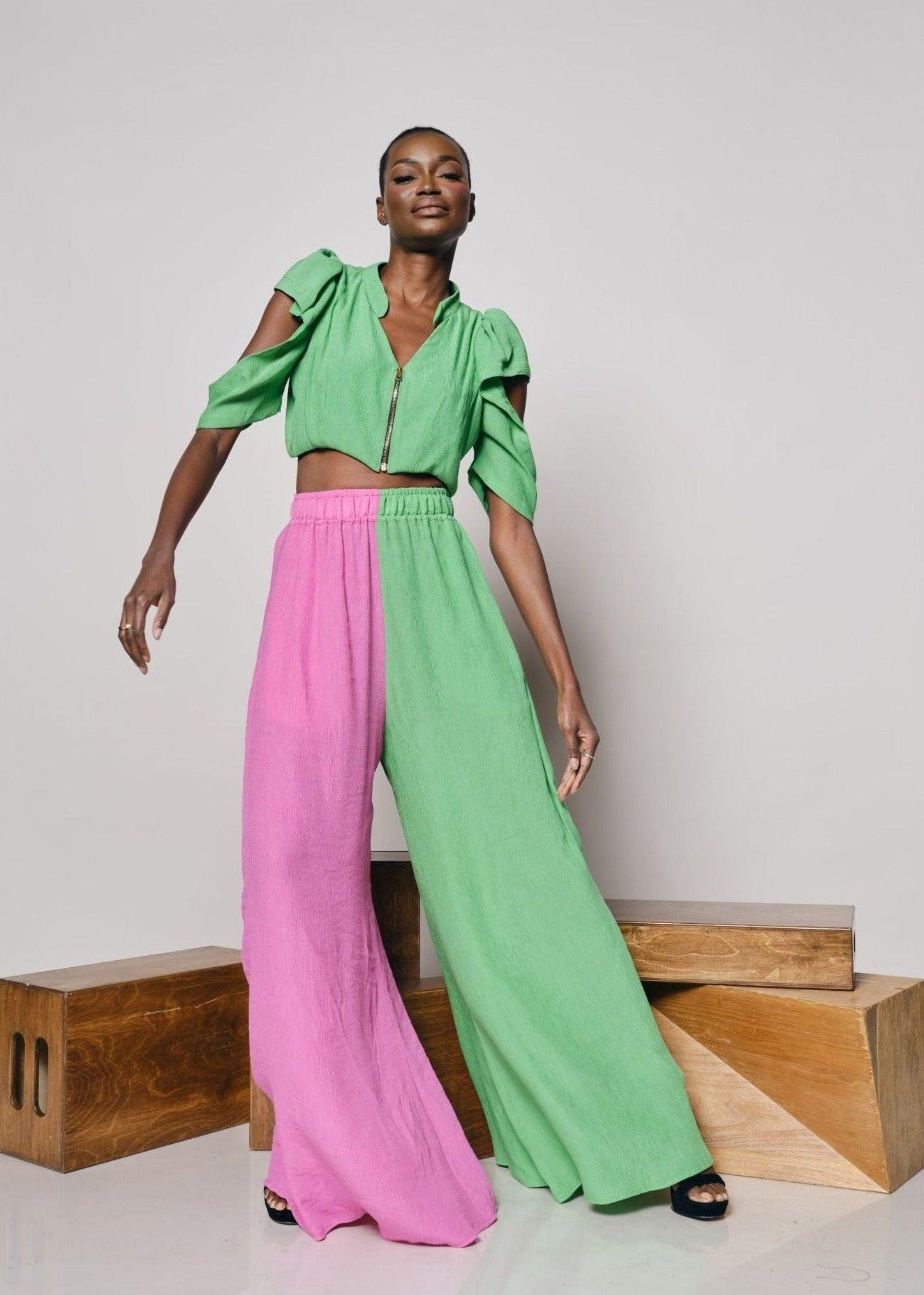 Model standing and showcasing the Bandiagara Pants in pink and green