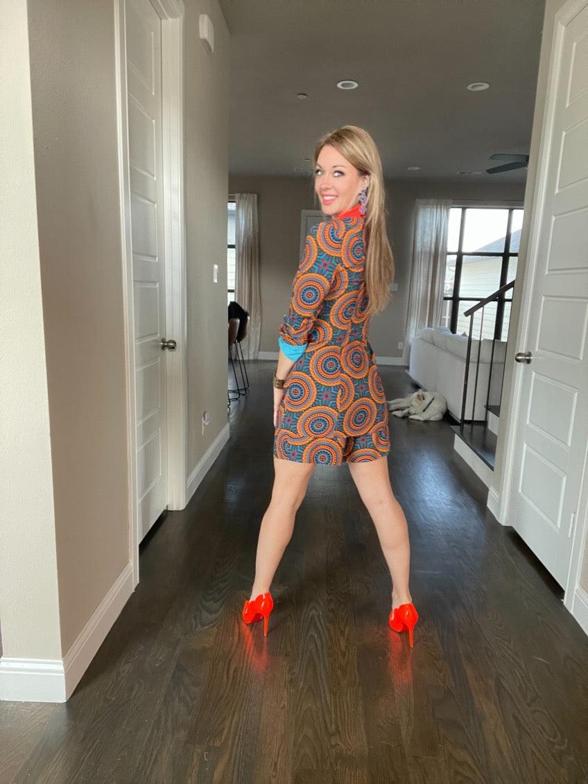 A woman modeling the Fiesta Shorts with a vibrant pattern