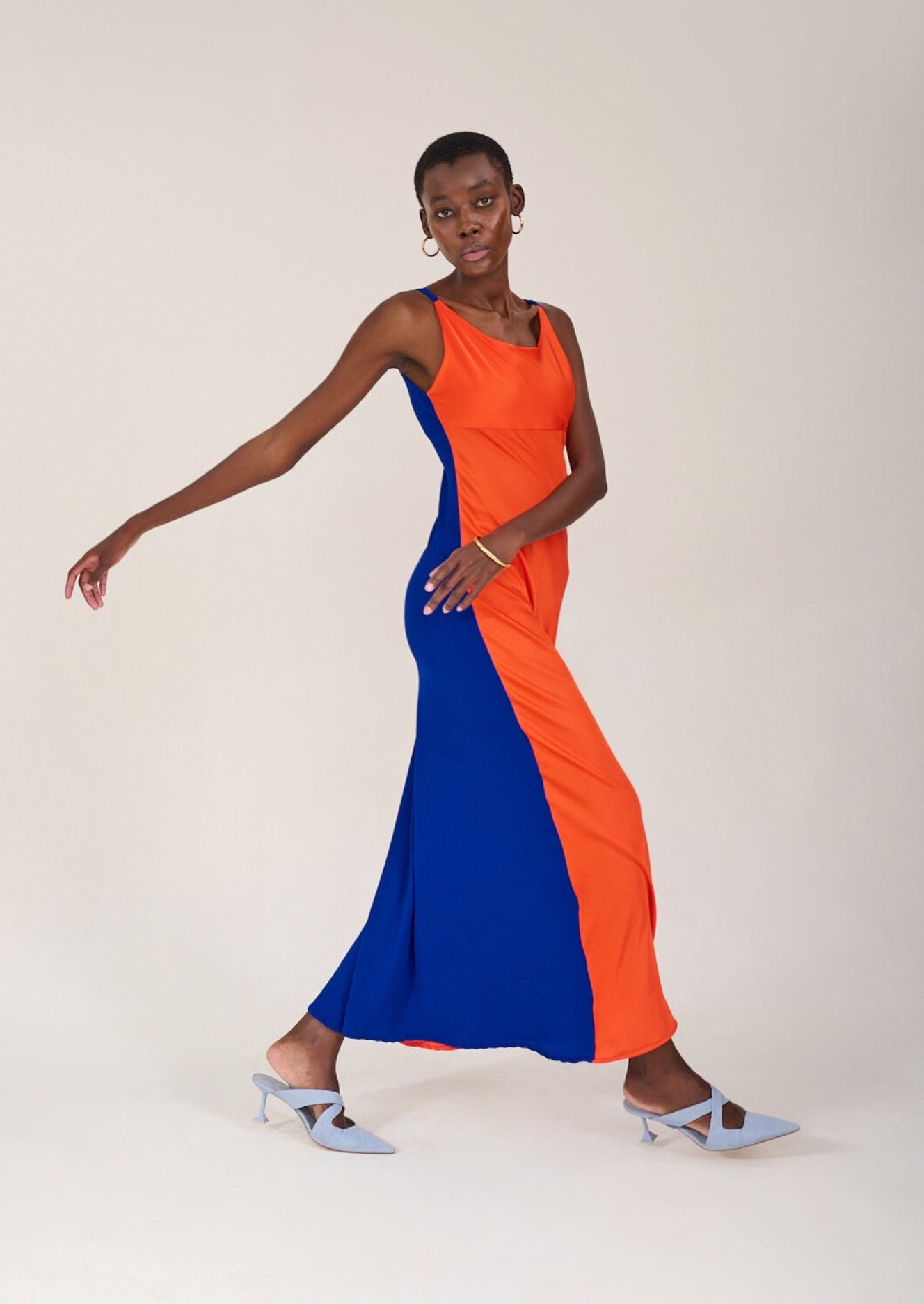 Model posing to show the curved silhouette of the KAHINDO Capepoint Slip Dress