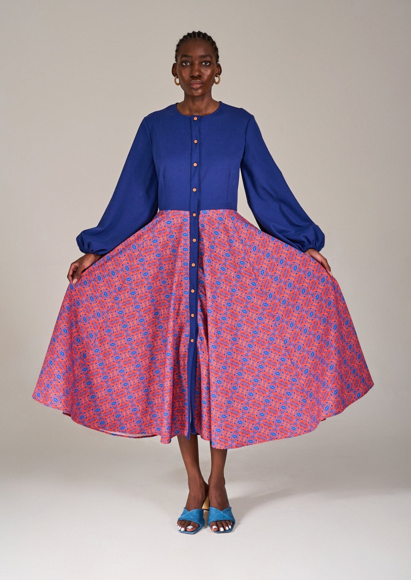 Model in the KAHINDO Kirstenbosch Shirtdress holding both sides of the full skirt