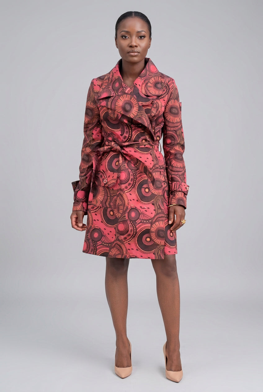 Person wearing a pink and brown patterned dress on a white background