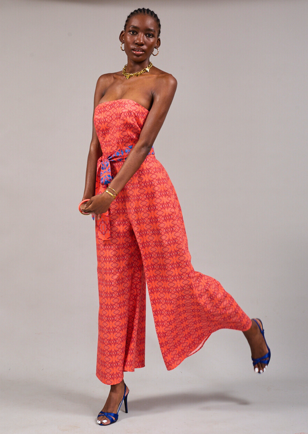 Model with hands held at the front standing on one foot, wearing the KAHINDO Beau Strapless Jumpsuit