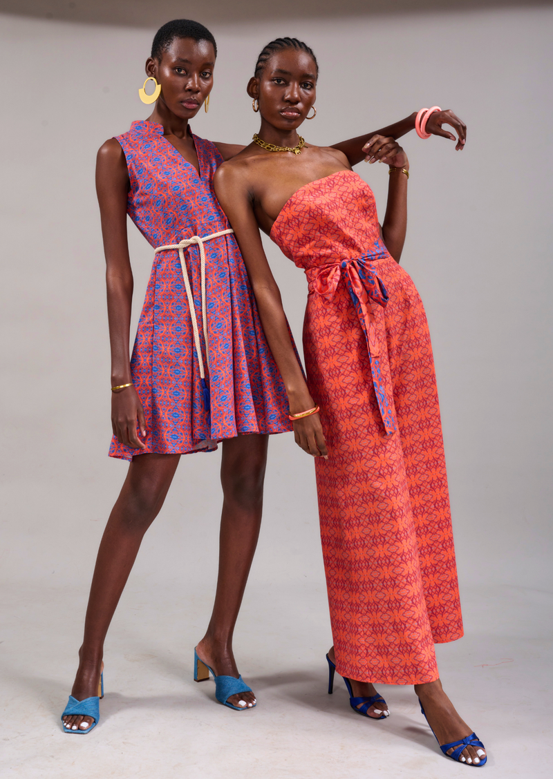 Two models leaning on each other wearing the Beau Strapless Jumpsuit and the Houtbay Sleeveless Dress