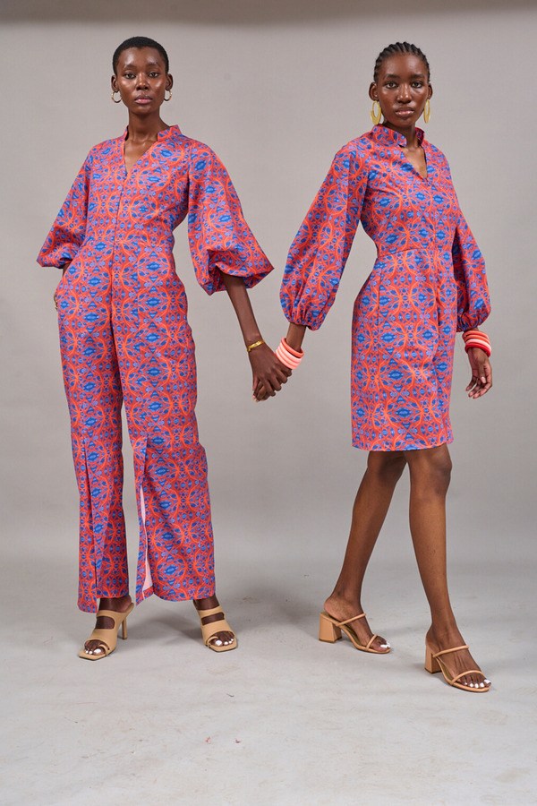 Two models posing together holding hands wearing the Nobu Jumpsuit and Claremont Romper by KAHINDO