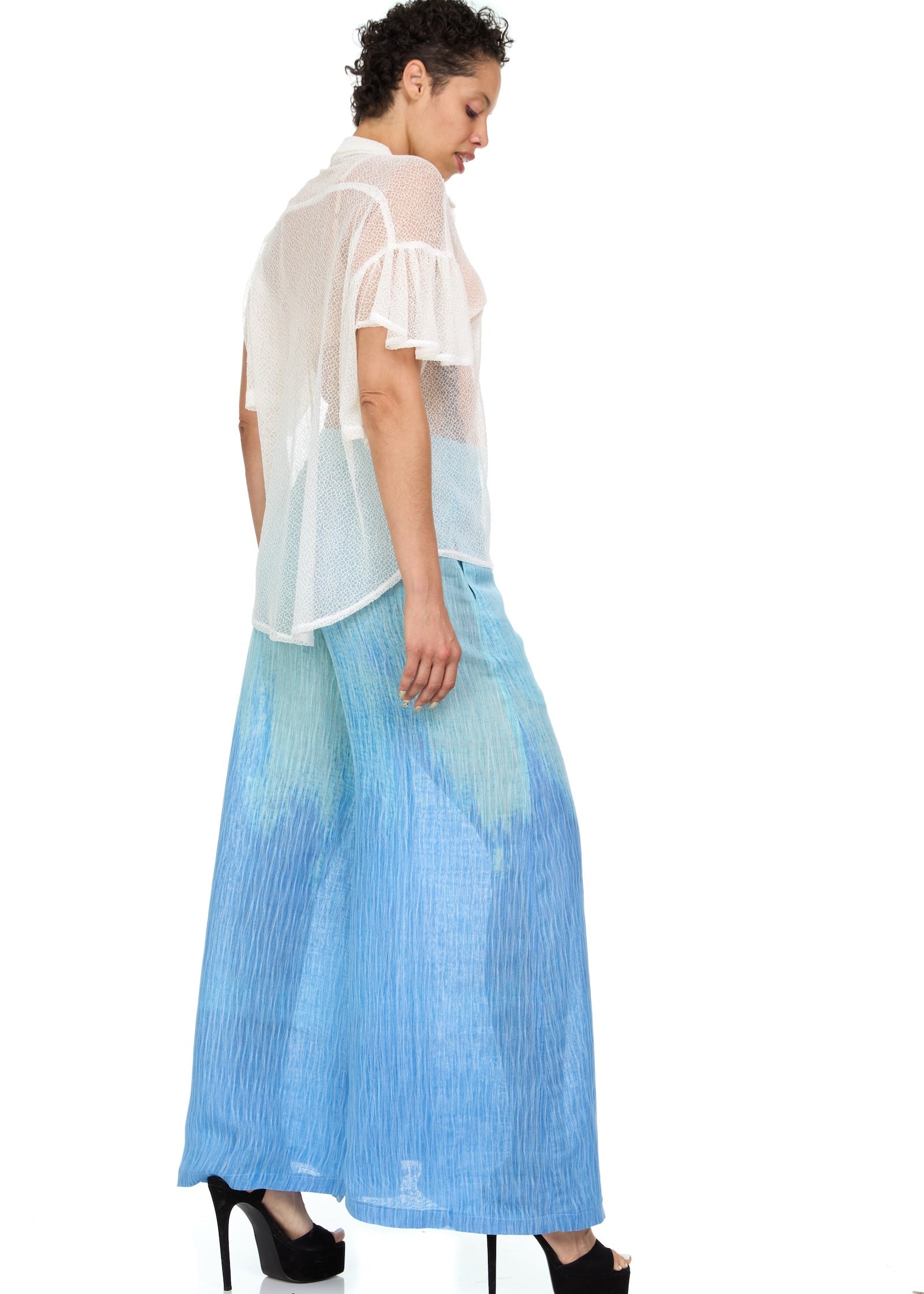 Woman modeling the Ombre_Wide-Leg_Trousers styled with a white lace shirt