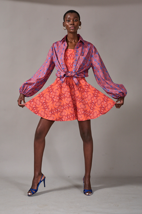 Model holding the ends of the Queensroad Strapless Dress, styled with the Stellenbosch Button Down on top by KAHINDO