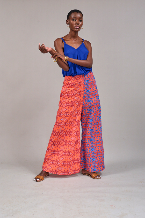 Model posing with arms up wearing the KAHINDO Sea Cami tucked into the Grand Pavilion Pants