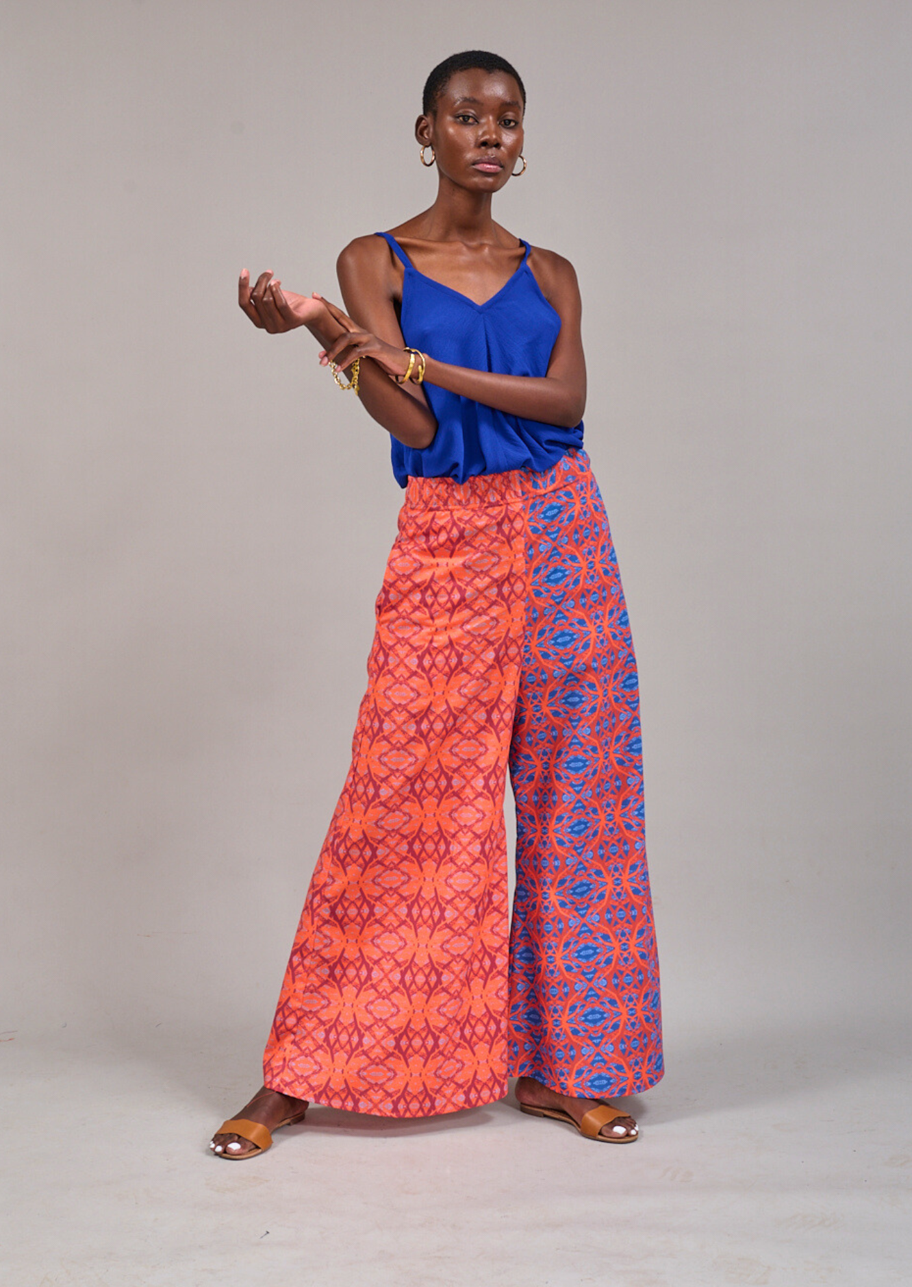 Model standing with raised hands wearing the KAHINDO Sea Cami Top and the Grand Pavilion Pants