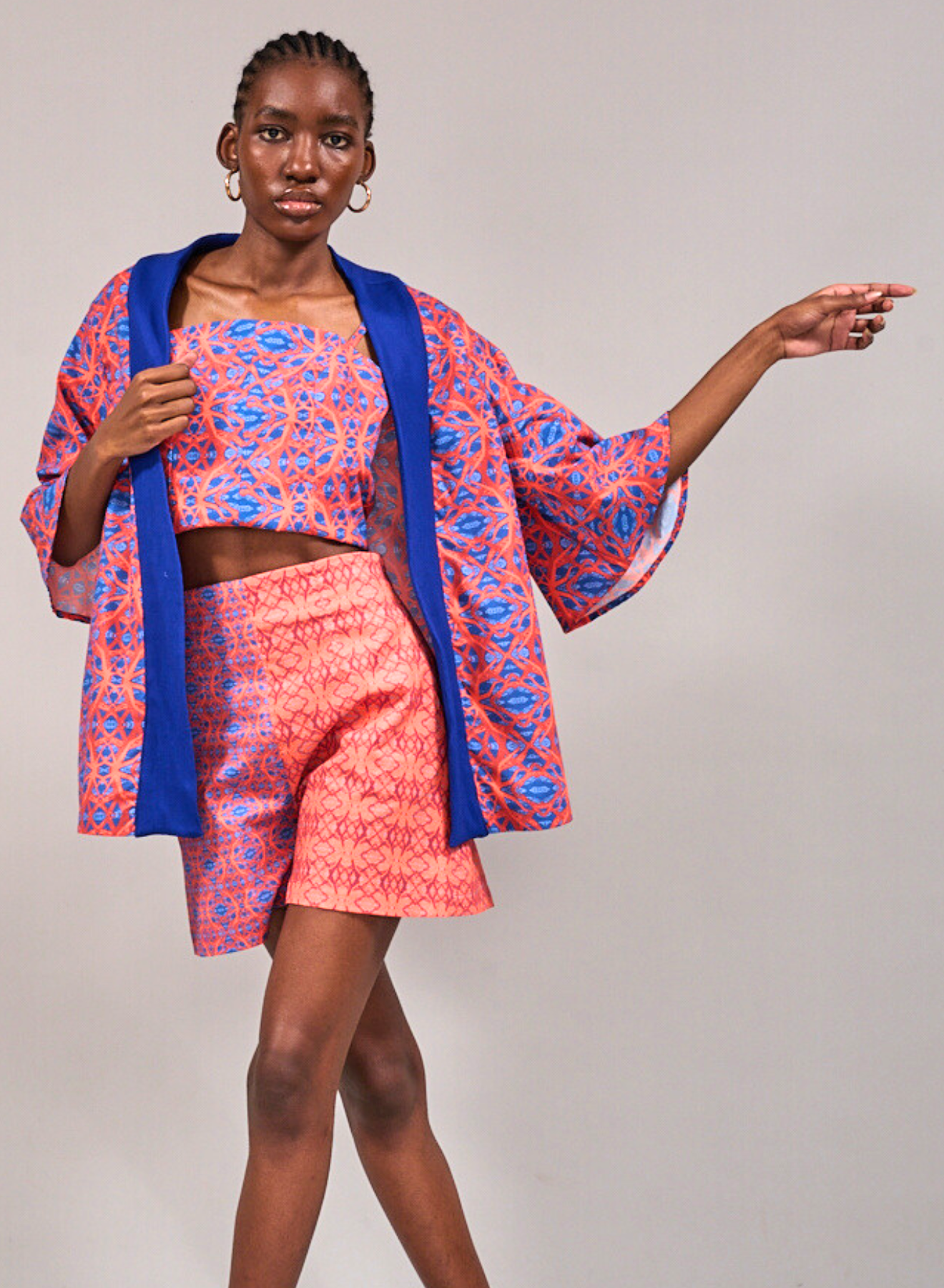 Close up shot of model standing with crossed legs wearing the Table Mountain Duster, Tang Top and the Constantia Shorts by KAHINDO