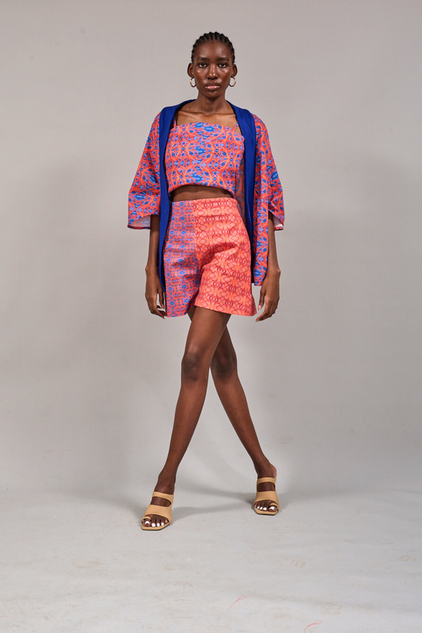 Model standing with crossed legs wearing the KAHINDO Table Mountain Duster, Tang Top and the Constantia Shorts