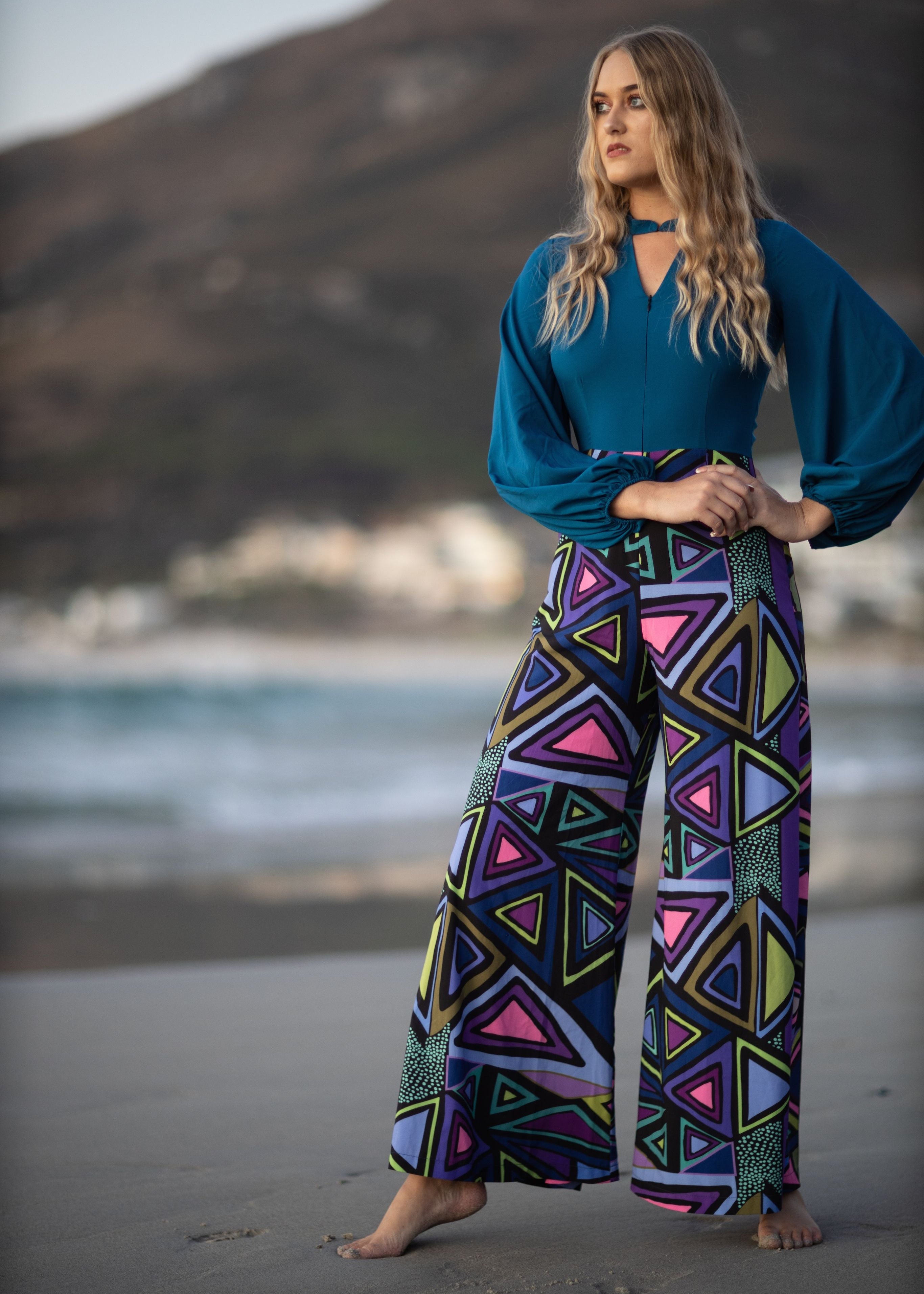 Model wearing the Zip Front Jumpsuit on the beach.