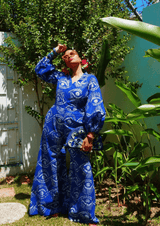 A woman modeling the Bahari Print Jumpsuit with blue and white patterns