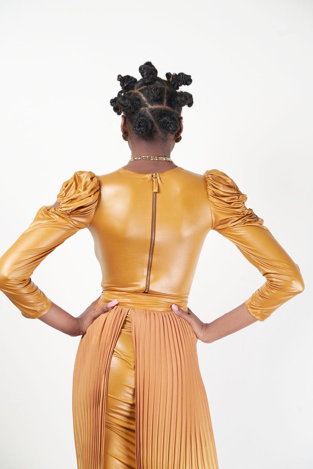 A model showcasing the Chad Midi Dress in a golden hue