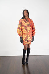 A woman modeling the Kyoga Long Bomber Jacket with a colorful pattern