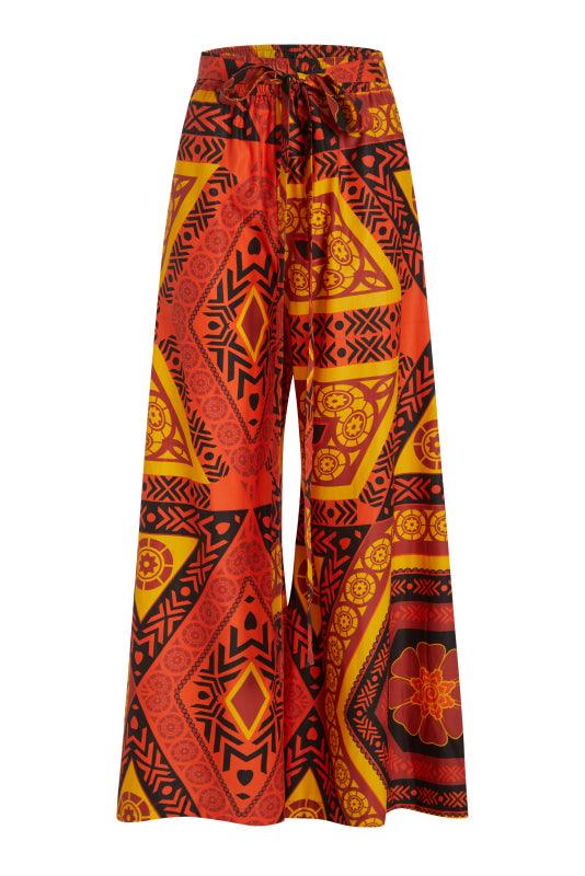 Mara Pants featuring an orange and black pattern design