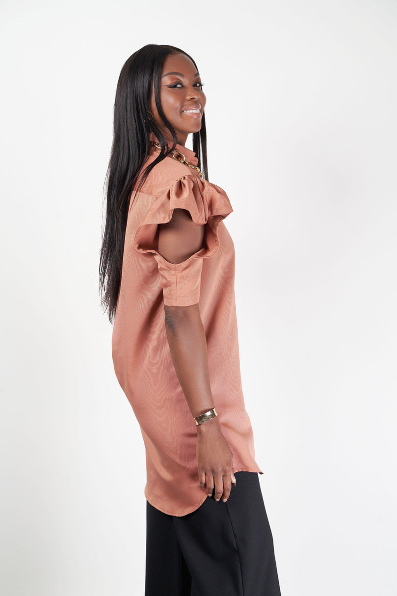 model showing shirtdress with cut out sleeves in peach