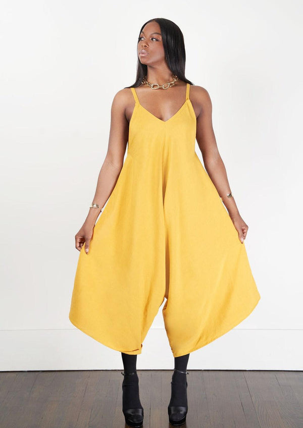 A model showcasing the 'Nile Jumpsuit' in yellow with a comfortable fit and elegant silhouette