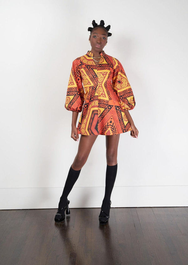 A model showcasing the Rukwa Dress with African print design, paired with boots