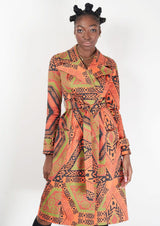 woman wearing orange and green african print trench coat