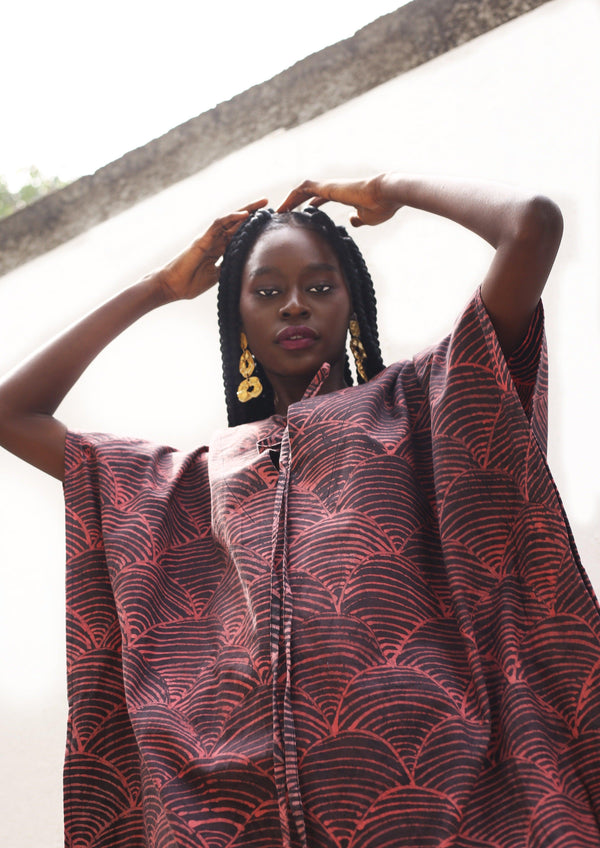 Close-up view of the Amboseli Kaftan's red and black print design