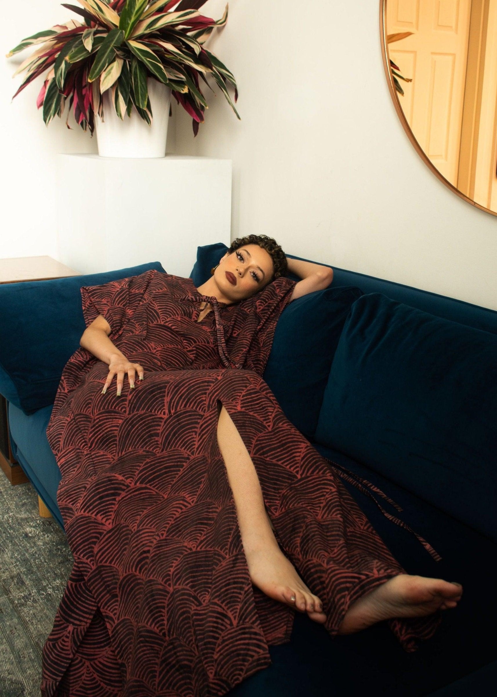 A model showcasing the Amboseli Kaftan with red and black patterns