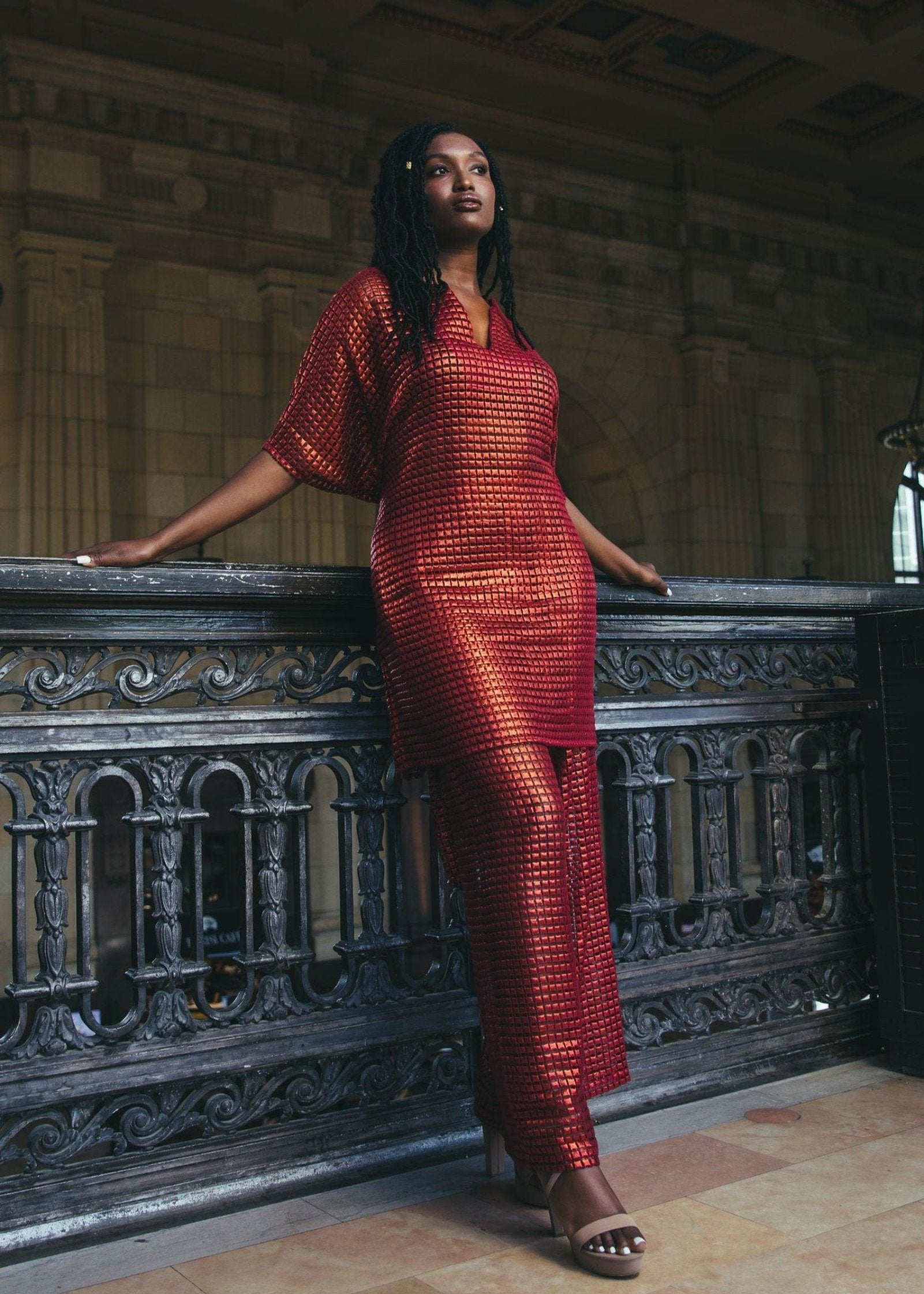 Side view of a woman modeling the Fangano Kaftan with a red and black pattern