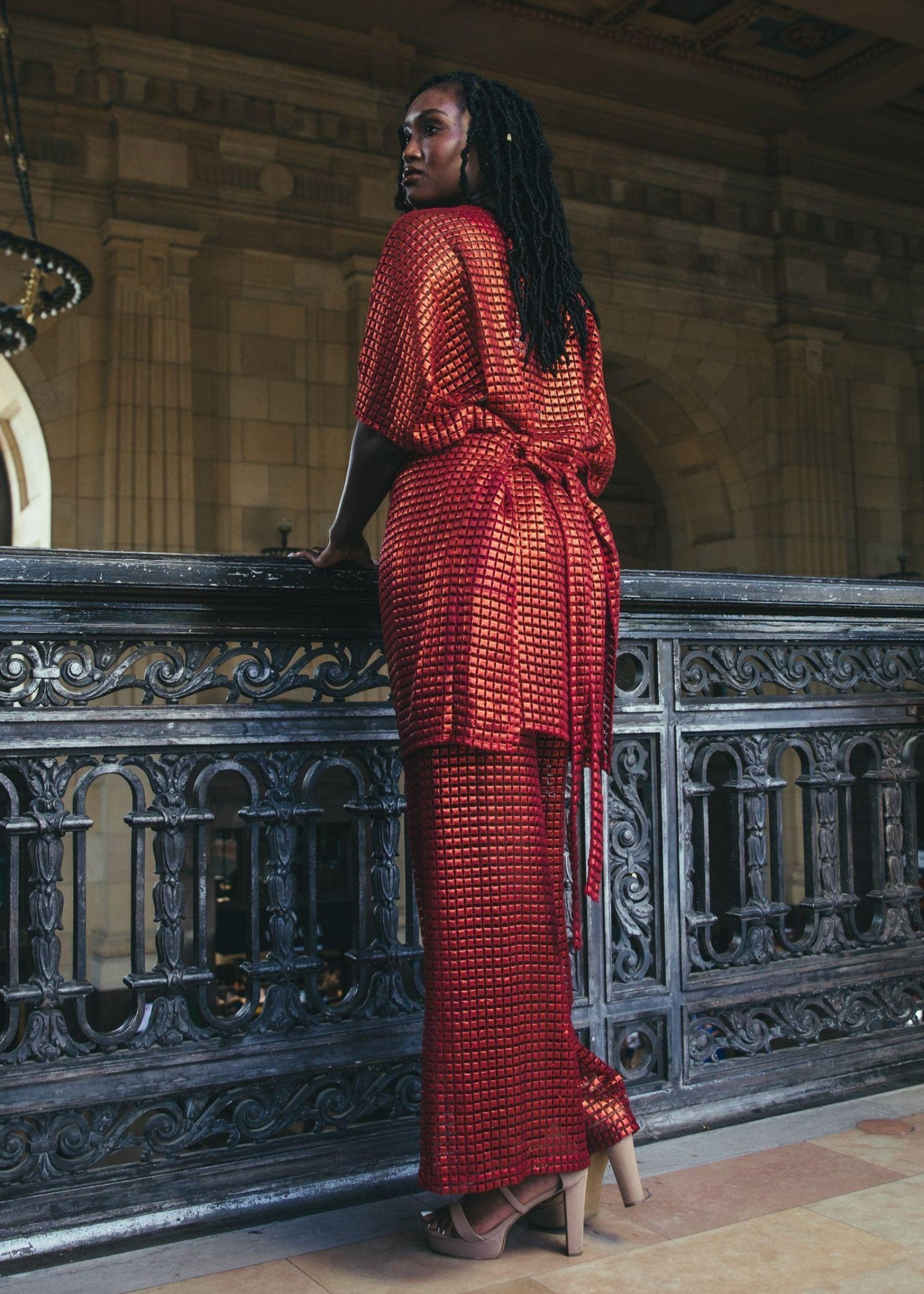 Rear view of Galu Pants in red with a black accent