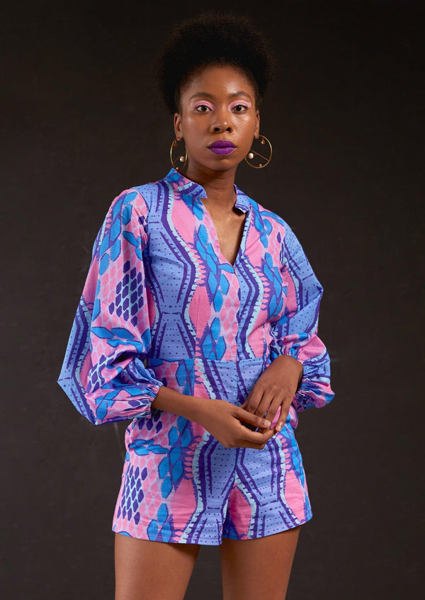 Side view of a woman modeling the Kisumu Romper with a blue and pink pattern