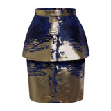 Makena Mini Skirt showcasing its metallic blue and gold design